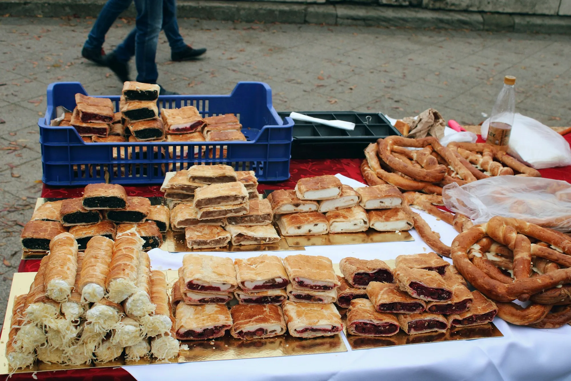 A market table piled with fresh pastries and baked goods for sale