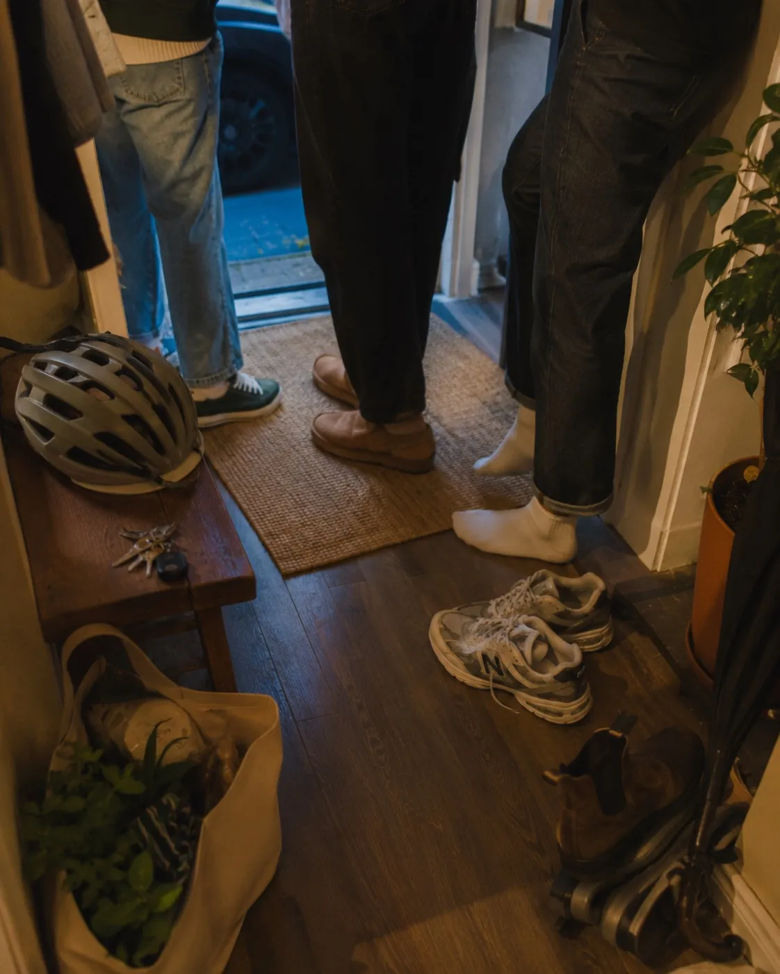 the hallway of a shared home, shoes by the door